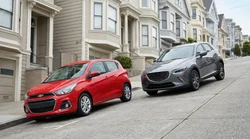 White compact car rental parked tightly on a steep residential hill in San Francisco