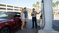 Driver pumping fuel into a modern car rental vehicle at a Las Vegas gas station