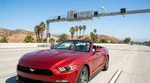 White car rental driving under an electronic highway toll booth in California