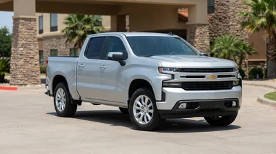 Silver car rental driving along a rural desert highway in Texas