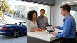 Customer handing a credit card to an agent at a car rental counter in San Francisco