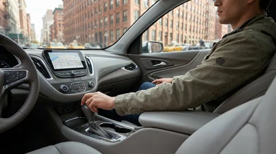 Close up of an automatic gear shift inside a car rental parked on a busy New York street