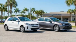 A compact and an intermediate car rental parked side by side next to palm trees on a sunny Florida beach road