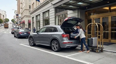 A car hire stopped on a busy San Francisco street for unloading luggage at a Union Square hotel