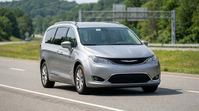 Silver car rental driving through an electronic toll booth on a Pennsylvania highway