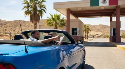 Silver car rental driving on a scenic desert highway in California