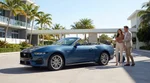 White convertible car rental driving past sunny palm trees on Ocean Drive in Miami