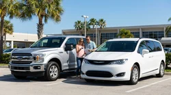 White car hire pickup truck parked on a sunny Florida beach with palm trees