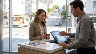 Customer handing a credit card to an agent at a car rental counter in San Francisco