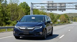 A white car rental passing through an E-ZPass toll booth on a Pennsylvania highway