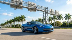 White car rental approaching an electronic toll plaza on a sunny Florida highway