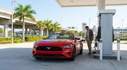 White car rental parked at a gas station pump near Miami Airport
