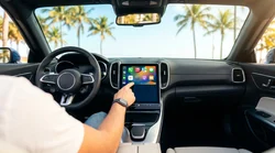 Apple CarPlay screen on a car rental dashboard with sunny Miami palm trees visible through the windshield