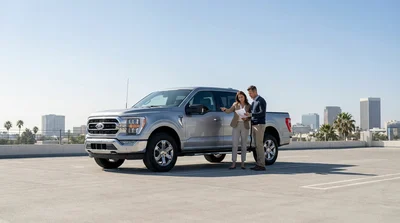 White SUV car rental driving along a long straight highway in the Texas desert