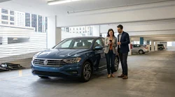Driver using a smartphone inside a car rental parked on a New York City street