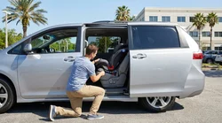 Modern ISOFIX child seat safely installed in the back seat of a car rental vehicle in Orlando