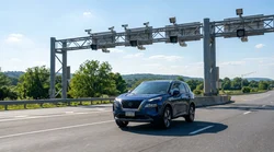 Rear view of a car rental driving under an electronic toll camera in Pennsylvania