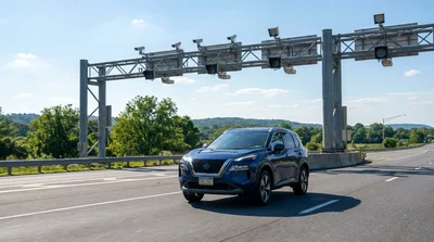 Rear view of a car rental driving under an electronic toll camera in Pennsylvania