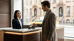 Customer handing a credit card to an agent at a car hire counter in New York