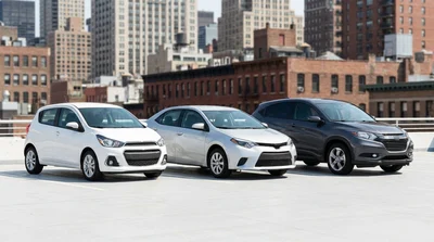 Compact car rental driving on a busy New York avenue surrounded by tall skyscrapers