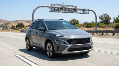 White car rental driving on a California highway under an express lane toll sign