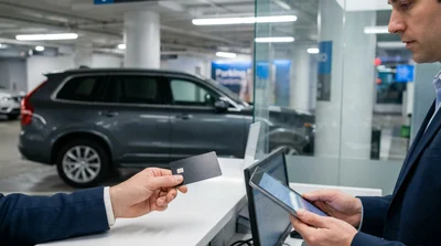 Close-up of hands passing a credit card across a car rental counter in New York
