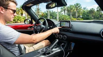 Close-up of a car dashboard showing a navigation screen and USB ports in an Orlando car rental