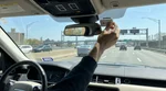 E-ZPass tag on the windshield of a car rental driving on a New York highway