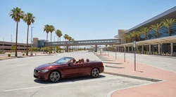 Passengers loading luggage onto a shuttle bus at a car rental lot in Las Vegas