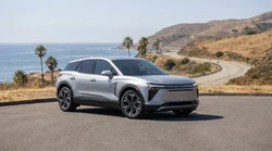 Modern electric car rental driving on a sunny coastal highway in California