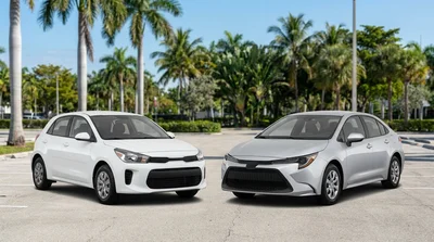 White economy and red compact car rental vehicles parked side by side on a sunny Miami street