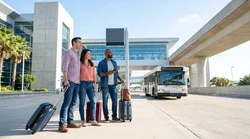 White car rental shuttle bus picking up passengers outside George Bush Airport in Texas
