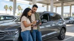 Customer handing a credit card to an agent at a car rental desk in the United States