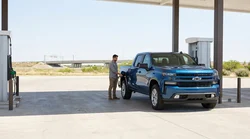 Person filling up a car hire at a gas station pump in Texas