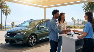 Customer handing a credit card to an agent at a car rental desk in California