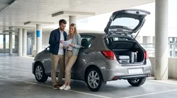 Close up of a person pumping gas into a car rental at a New York gas station