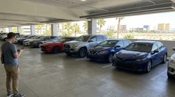 Rows of vehicles parked in the pick-up bays of a Las Vegas car rental garage