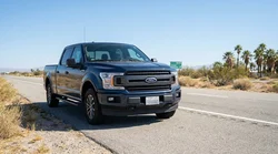 A white car rental driving on a scenic highway in California