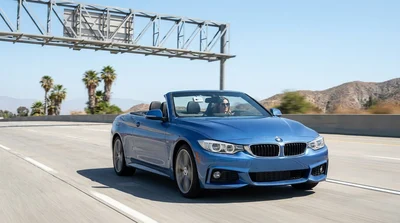 Driver navigating a car rental through a FasTrak express lane on a California highway