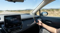 Driver plugging a USB cable into the dashboard screen of a car rental in Texas