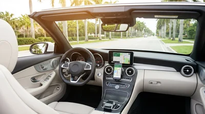 Smartphone showing a navigation map mounted on the dashboard of a car rental in Miami