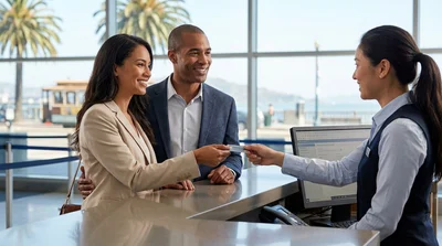 Customer handing a credit card to an agent at a car rental desk in San Francisco