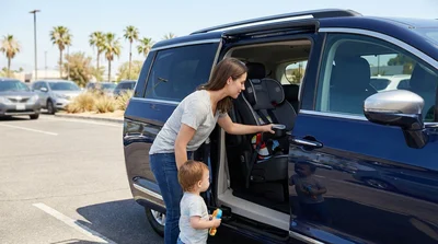 A modern child safety seat securely installed in the back of a car rental parked on a sunny street in Texas