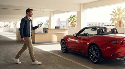 A traveler receiving keys from an agent at a car rental desk in Las Vegas