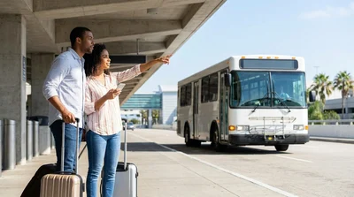 Hola car rental shuttle bus picking up passengers outside LAX Terminal 2 in Los Angeles