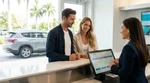 Customer signing documents at a Miami car rental counter next to an electronic toll pass