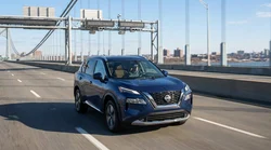 Silver car rental approaching a highway toll booth in New York