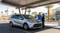 Driver checking a dashboard warning light inside a car rental vehicle at a Las Vegas lot
