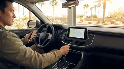 Smartphone showing a navigation route on the dashboard screen of a car rental in Las Vegas