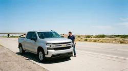 White car hire driving along a sunny desert highway in Texas
